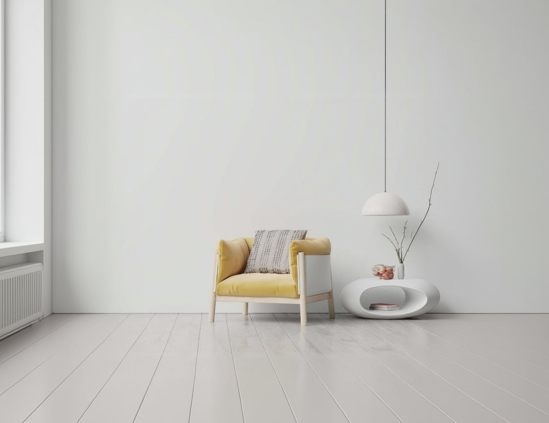 Yellow armchair with a patterned cushion in a minimalistic room.